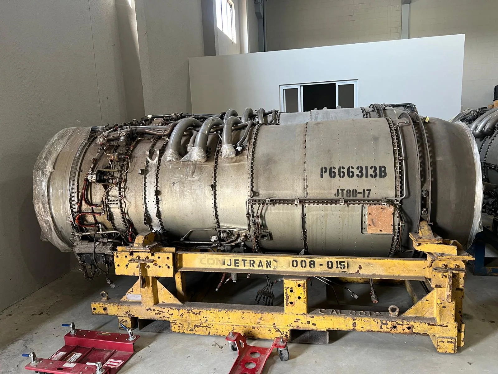 Side view of an aircraft engine on a transport frame.