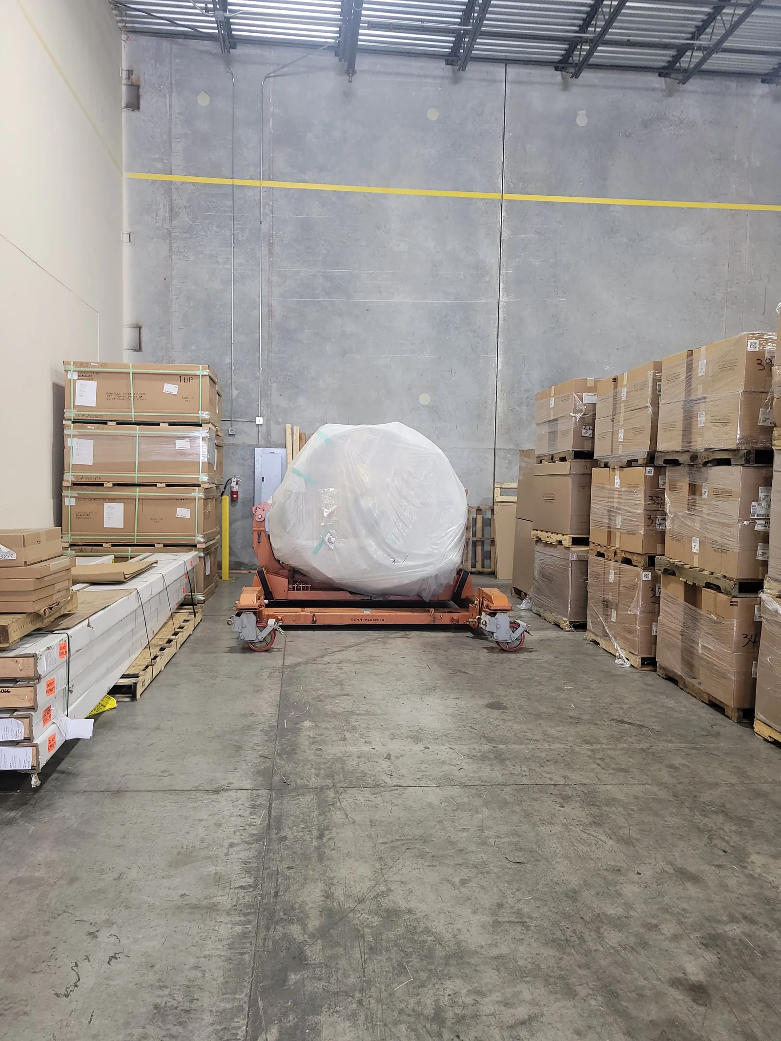 Another view of the wrapped component inside the warehouse.