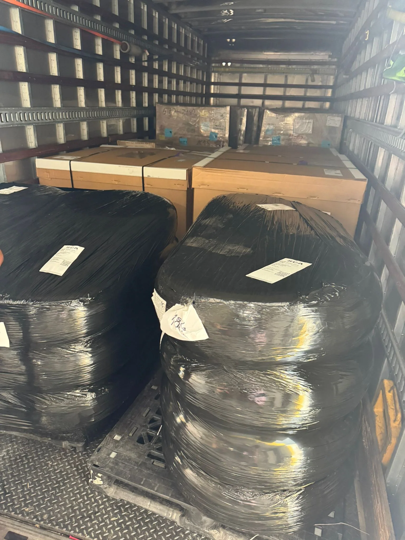 Wrapped components arranged inside a transport vehicle.