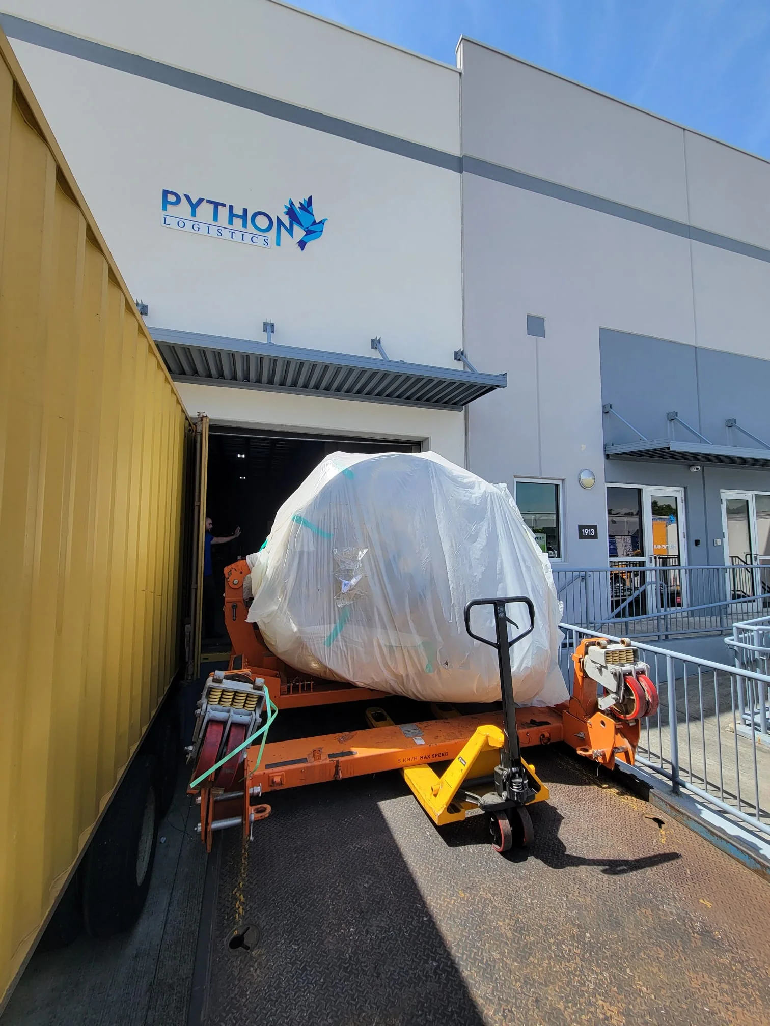 Wrapped component at a loading door of the Python Logistics facility.
