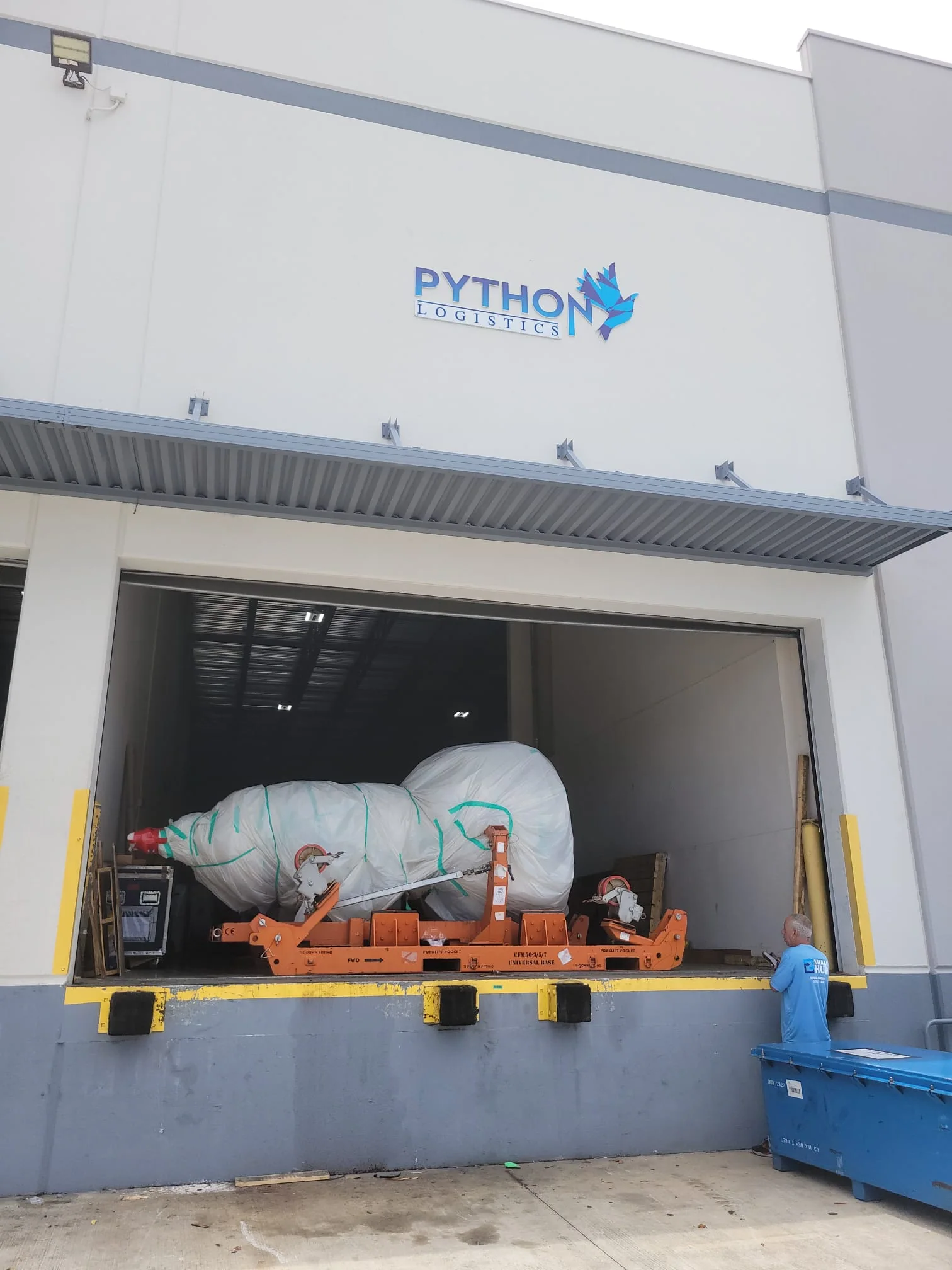 Wrapped component positioned at a Python Logistics loading door.