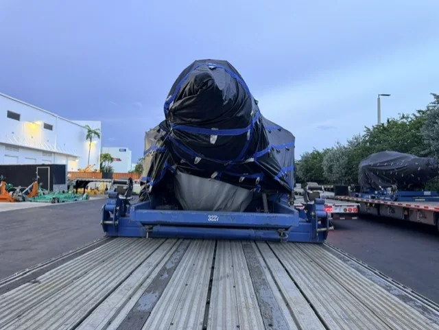 Covered component secured at the rear of a trailer.