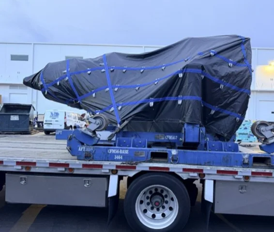 Long covered component positioned on a trailer.